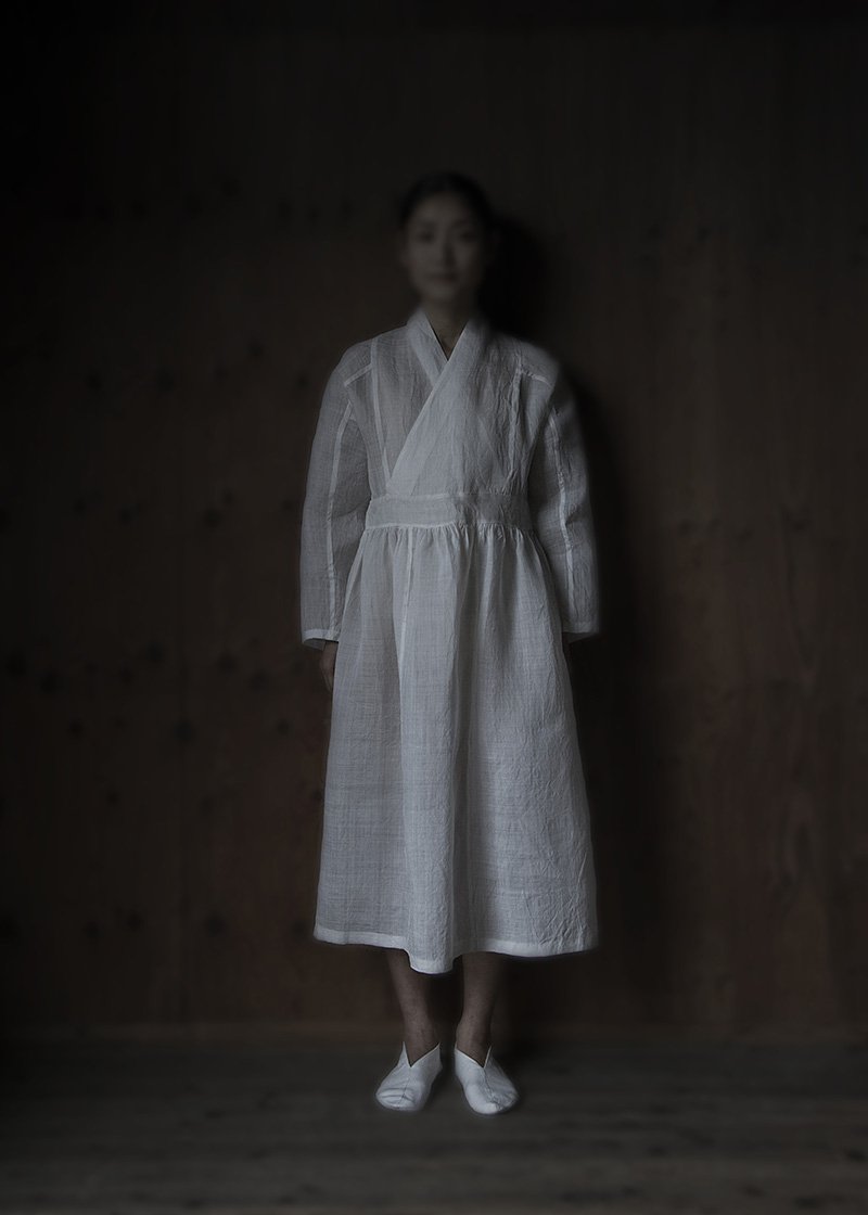 01. Karamushi work dress | whiteAll hand-sewn karamushi dress. Karamushi fabric is made from the fibers of karamushi vines. It is one of the oldest fiber crops, having been used to produce fabrics for the past six thousand years. The fabric is completed over many hand works by matured craftsmen. Comes in white and wildflower herbal dye.