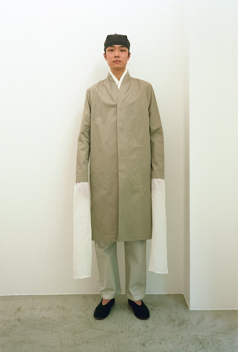 14. Collarless trench coat and Organic cotton wrapped pantsA collarless trench coat made from extra-long staple superior pima-cotton.