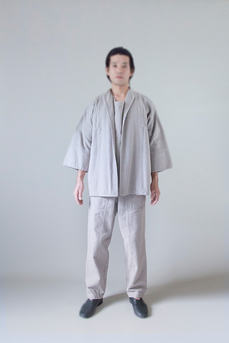 30. Sashiko work wear, Sashiko apron and Sashiko wrapped pantsFabric woven with sashiko techniques using shuttle weaving machine. Fabric is composed of organic cotton for the warp, and alternate layers of hemp threads and organic cotton for the woof. Sashiko stitches are cross woven with twisted hemp threads.