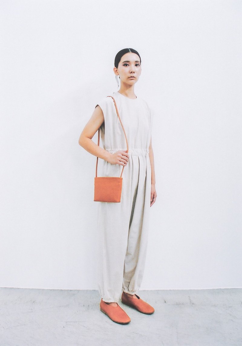 Organic cotton overalls and Naturally tanned leather shoulder pouch