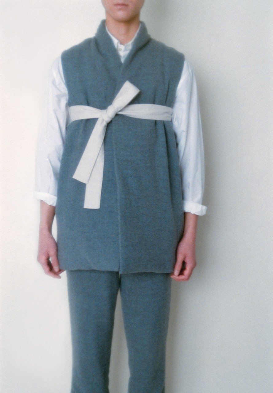 White colored folk down vest made of brushed wool and folk pants