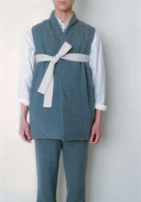 White colored folk down vest made of brushed wool and folk pants