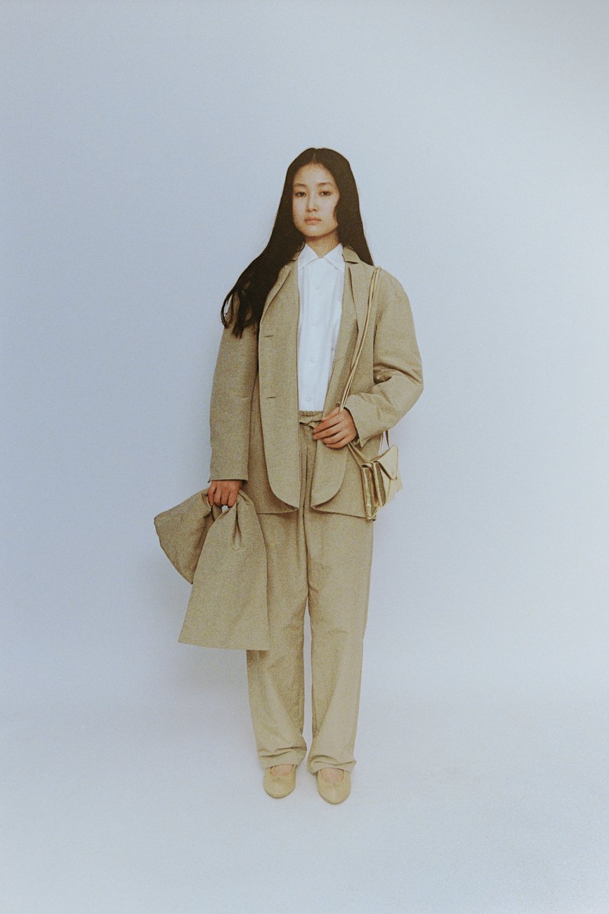 Folk dress pants with pleated tucks in the front. Fulgent gold leather envelope purse.