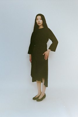 Wrapped dress with top combined with wrapped skirt and open back slit. Made of organic cotton broad.